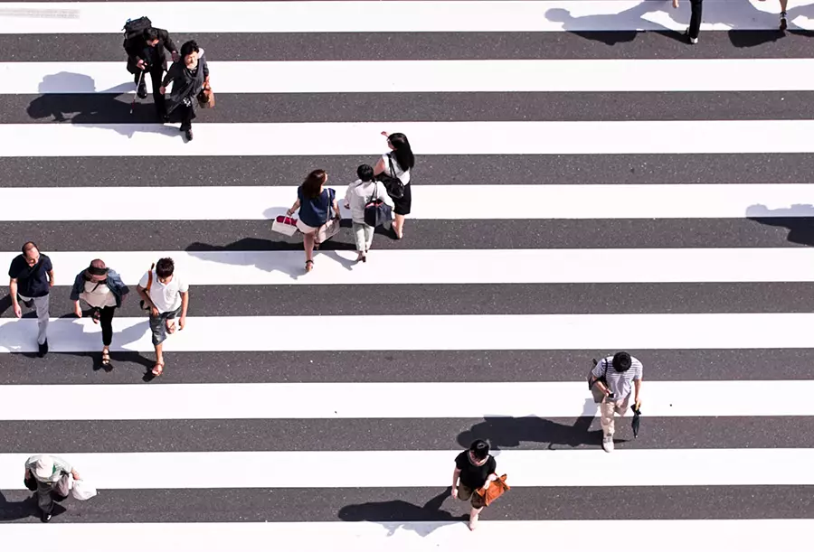 People cross the street in a crosswalk