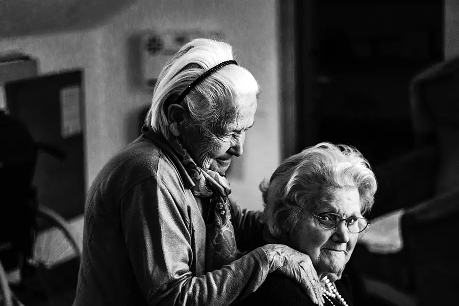 A pair of smiling elderly women